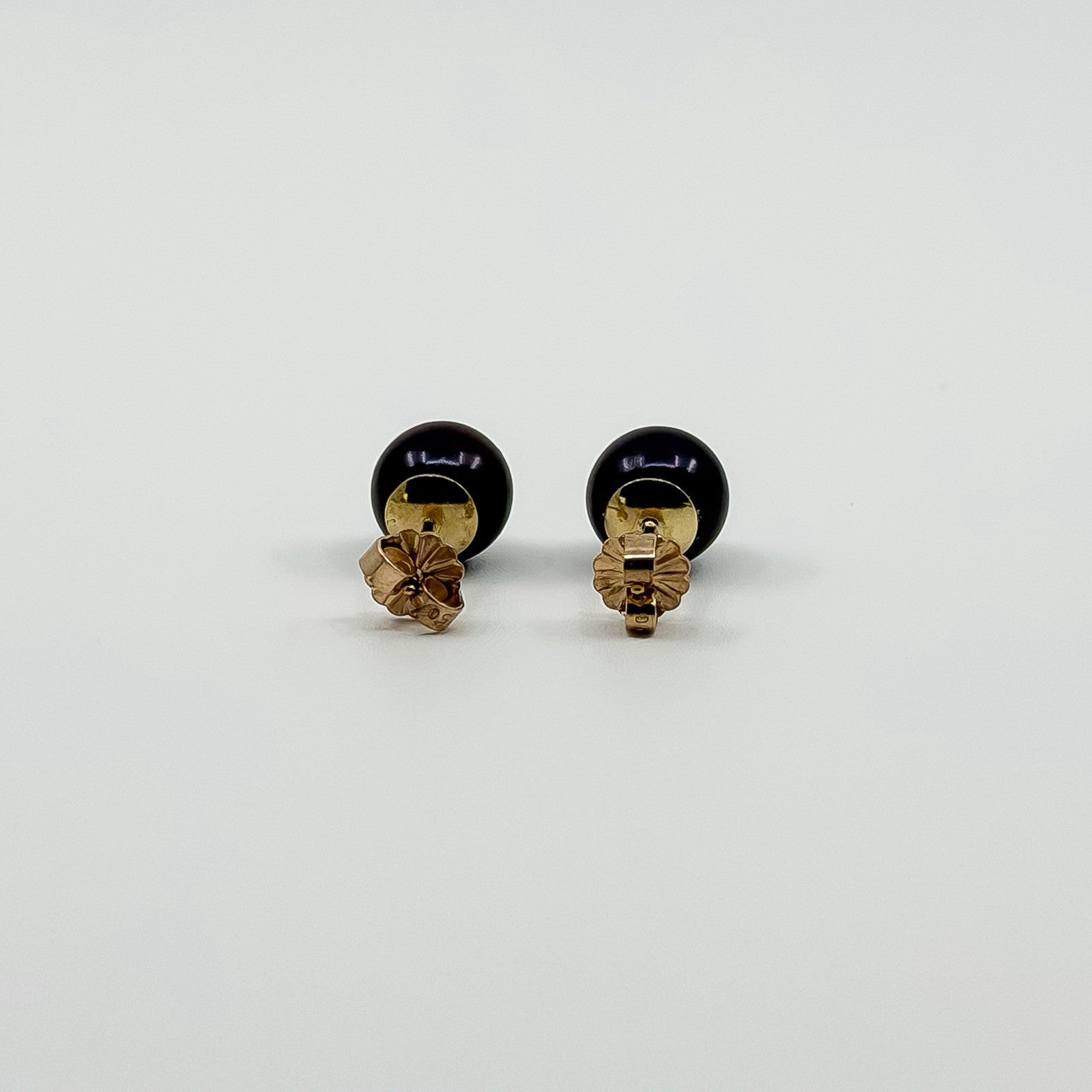 Back view of cultured black pearl stud earrings showing 9ct gold butterfly backs and 375 stamp