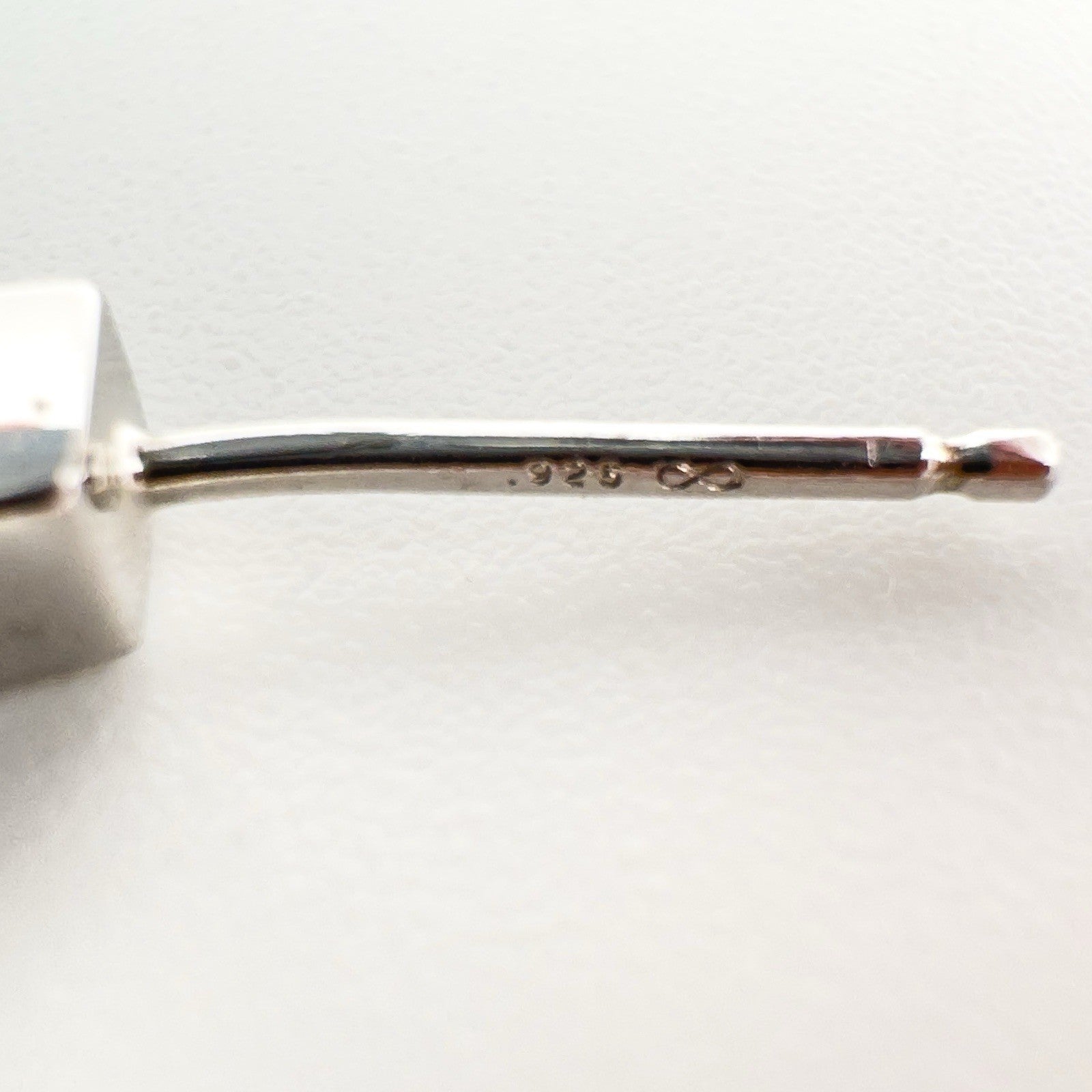 Macro close-up of the 925 hallmark and maker's mark on the earring post