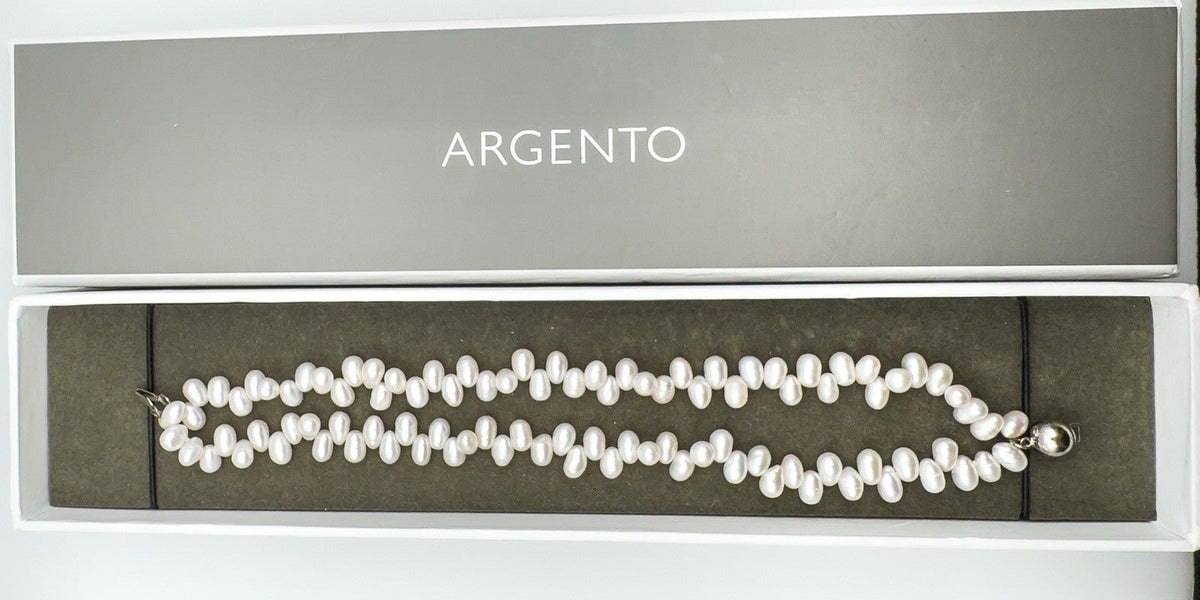 Double row pearl bracelet laid in box with ARGENTO branding