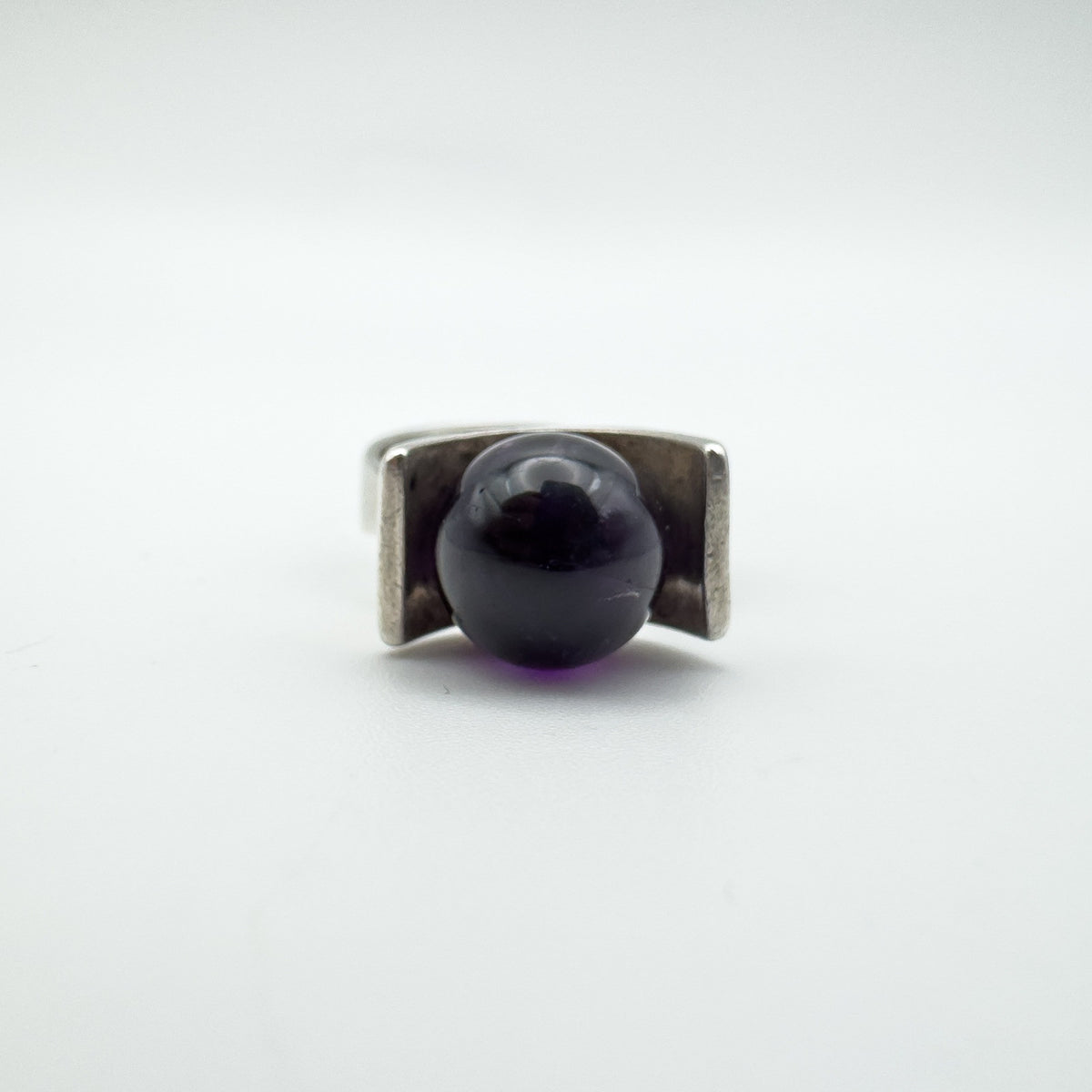 Close-up of amethyst ball set in modernist sterling silver ring