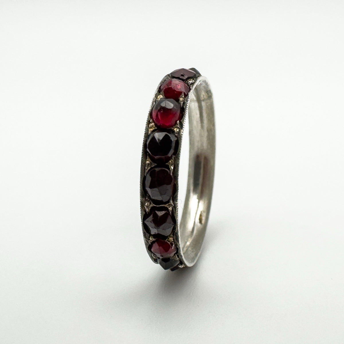 Side angle showing deep red rose cut garnets in sterling silver setting