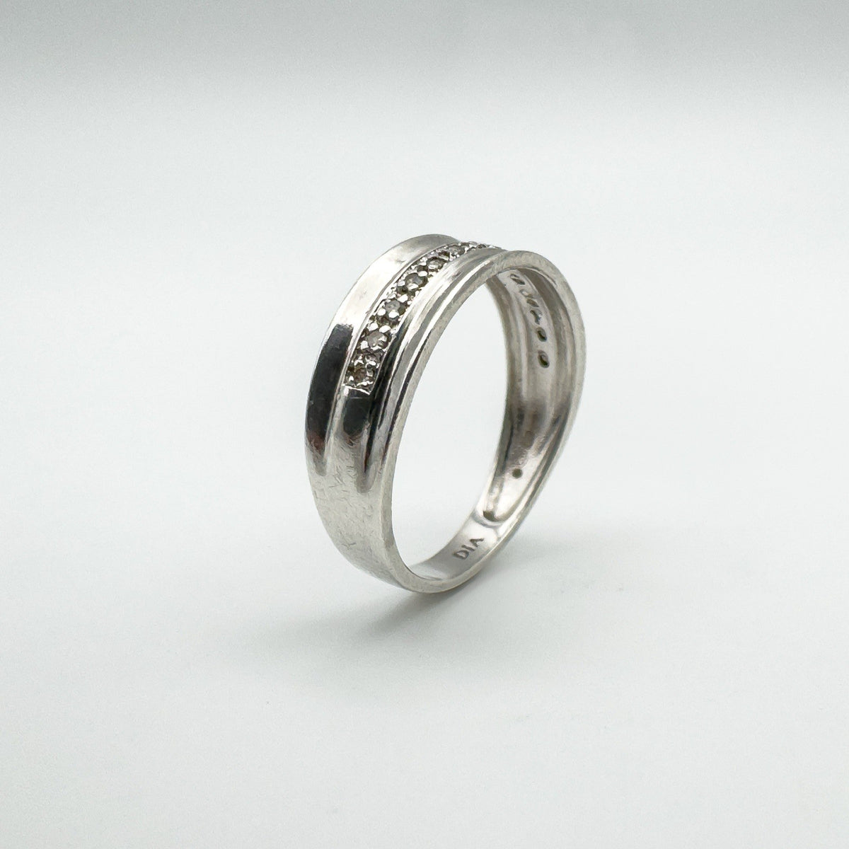 Angled view showing diamond setting and inside band marked 925 and DIA