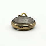 Side view of antique rolled gold double sided glass photo locket with bail and rounded case