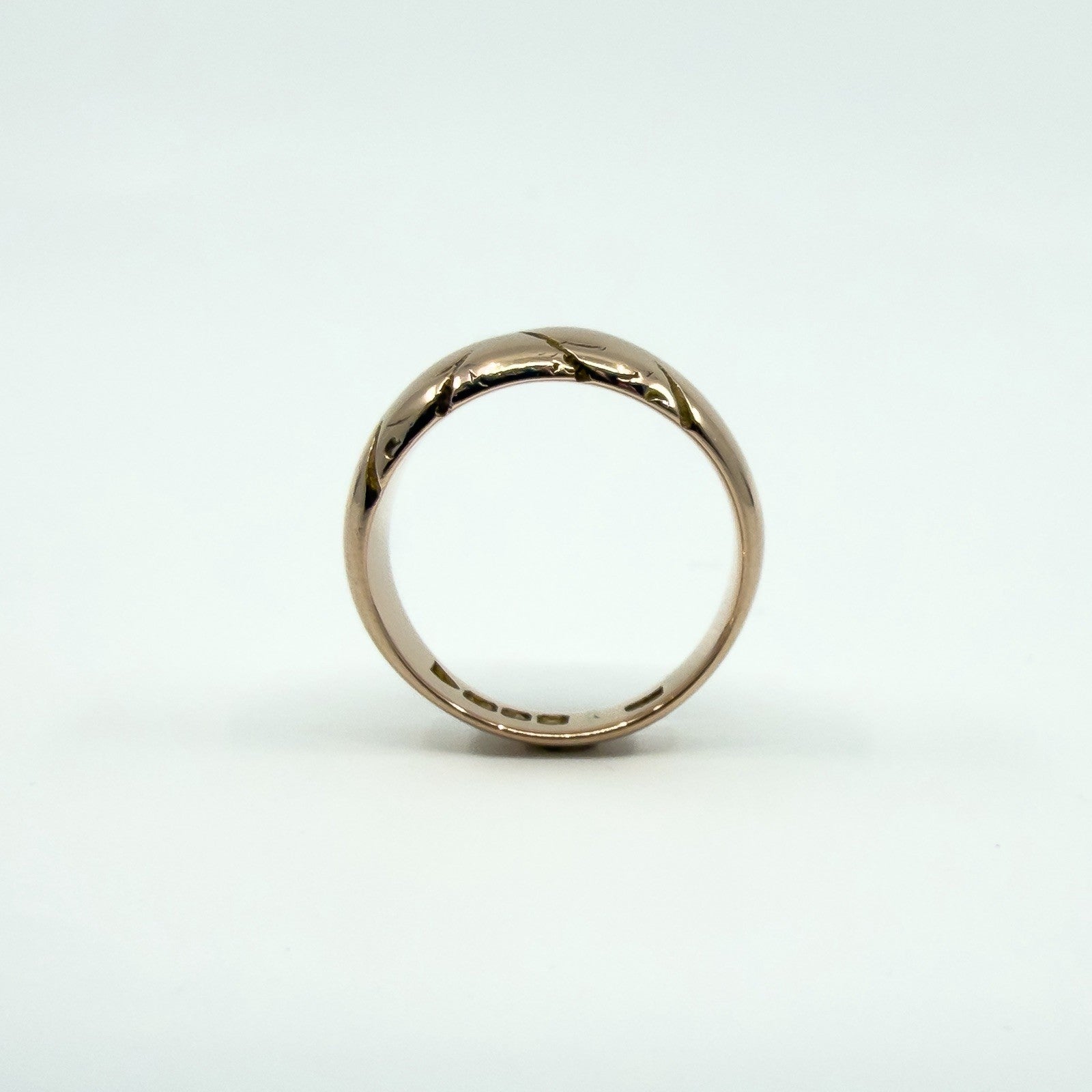 Side profile of antique 12ct rose gold wide band ring, Size J, showing chunky domed band