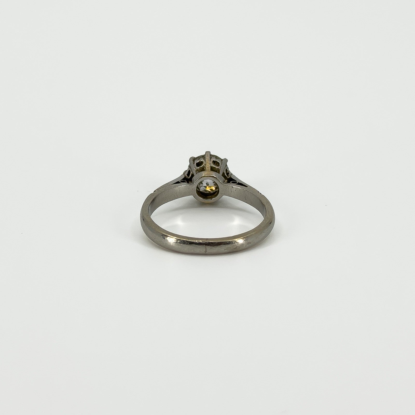 Back view of antique platinum old-cut diamond solitaire ring showing the gallery and shank