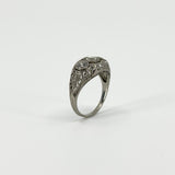 Angled view of Art Deco platinum diamond ring with engraved filigree shoulders