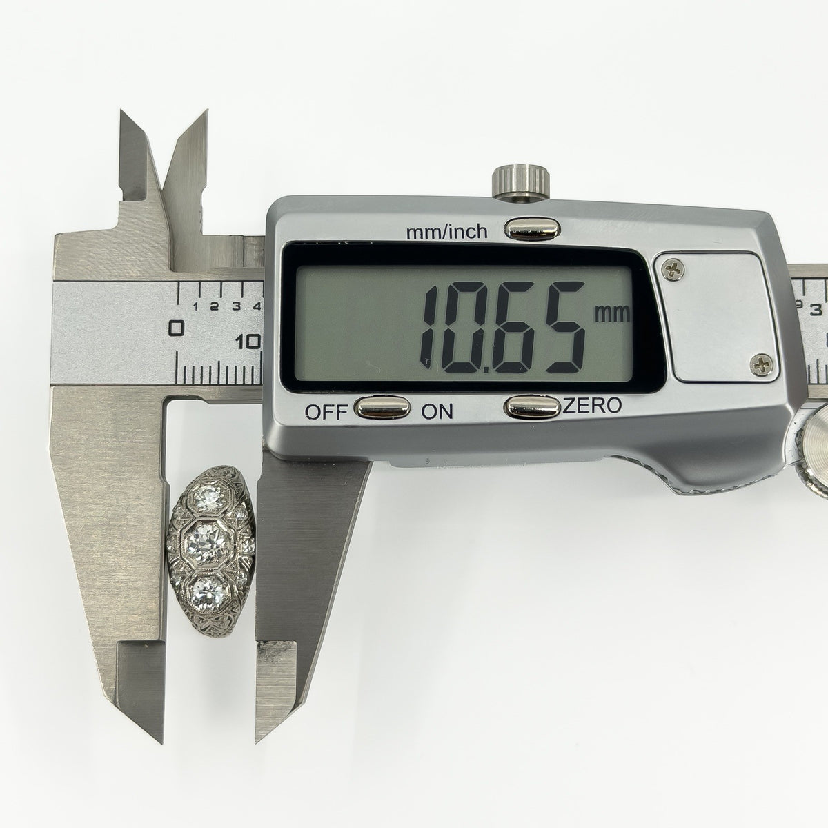 Art Deco platinum diamond ring measured with calipers at approximately 10.65mm