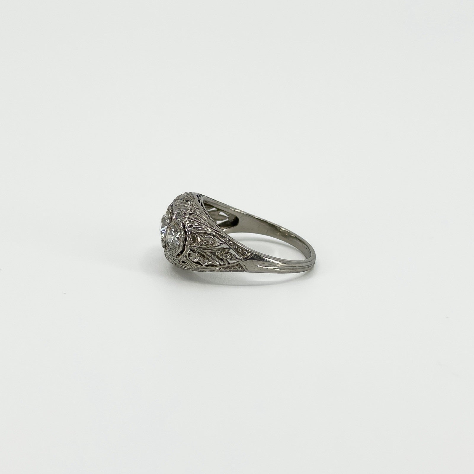 Close side view of Art Deco platinum trilogy ring with old-cut diamonds