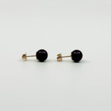Side view of 9ct gold cultured black pearl stud earrings with posts and butterfly backs