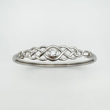 Well-lit front-facing view of Celtic bangle with centred cubic zirconia