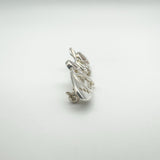 Angled detail showing side profile of sterling silver and shell Celtic brooch