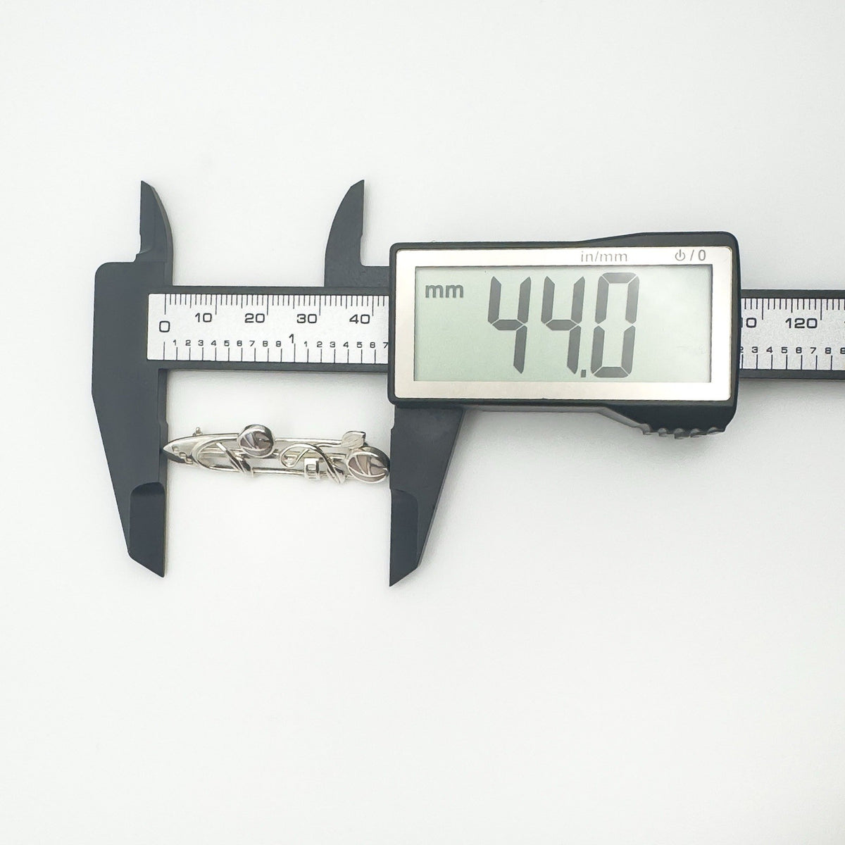 Measuring width of Celtic sterling silver brooch at 44mm