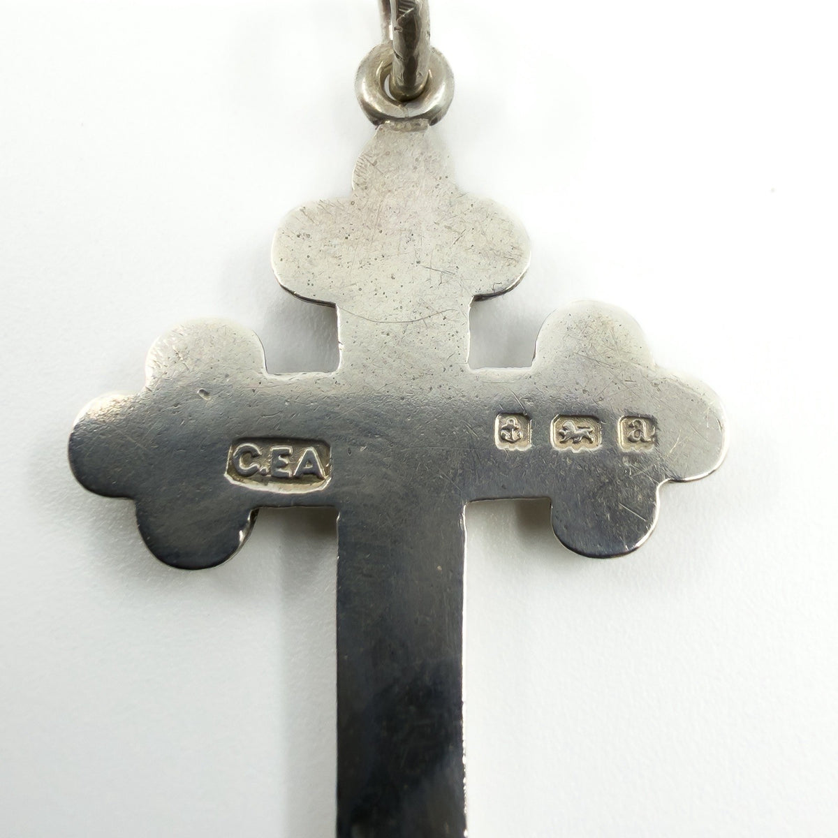 Close up of CEA maker mark and Birmingham 1900 hallmarks on the back of the silver cross