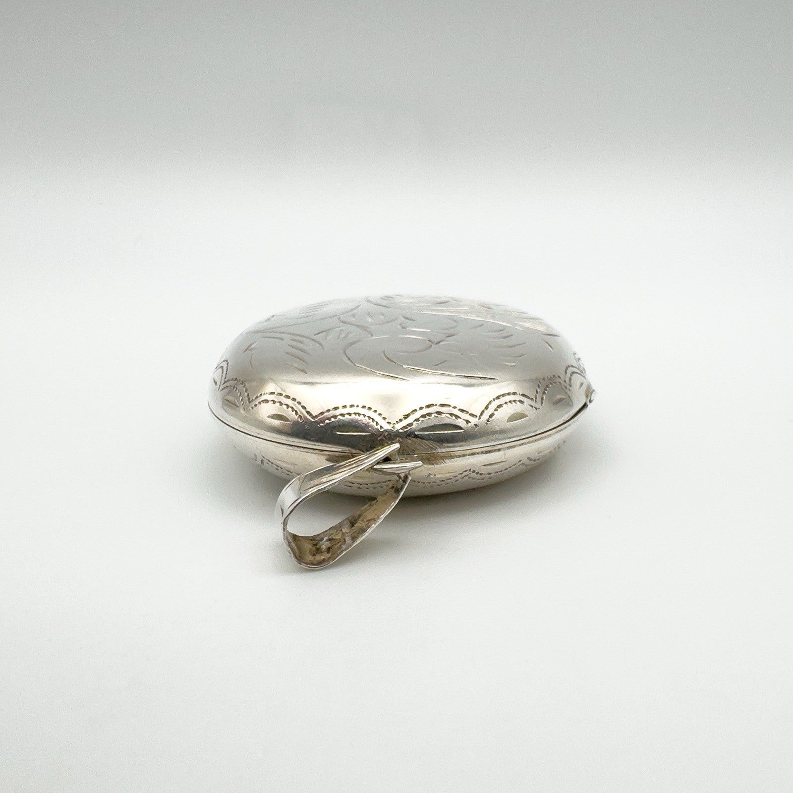 Top view showing large silver bail and engraved edge