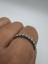 Close-up of platinum diamond eternity ring showing prong setting and sparkle