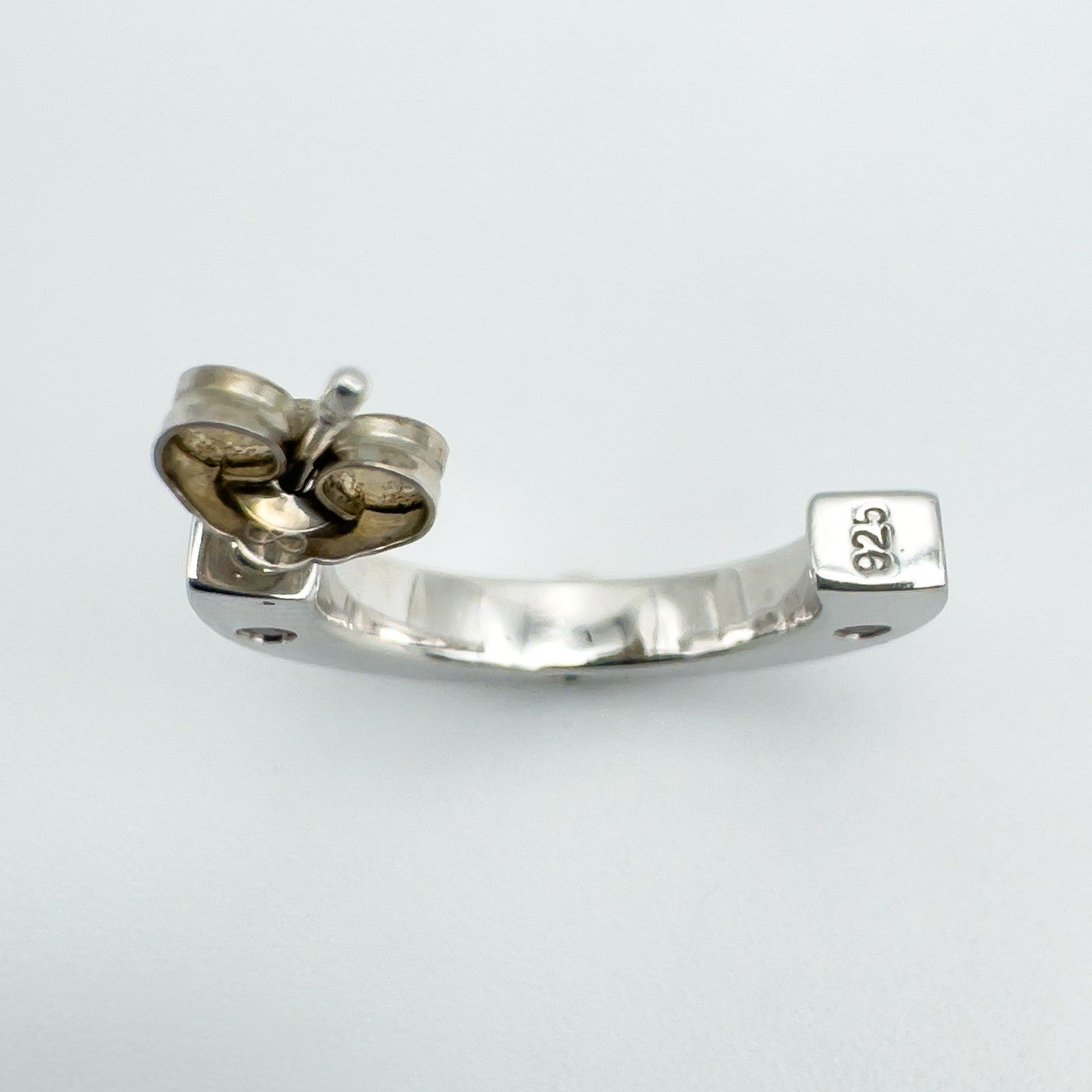 Close-up detail showing 925 sterling silver stamp on earring post