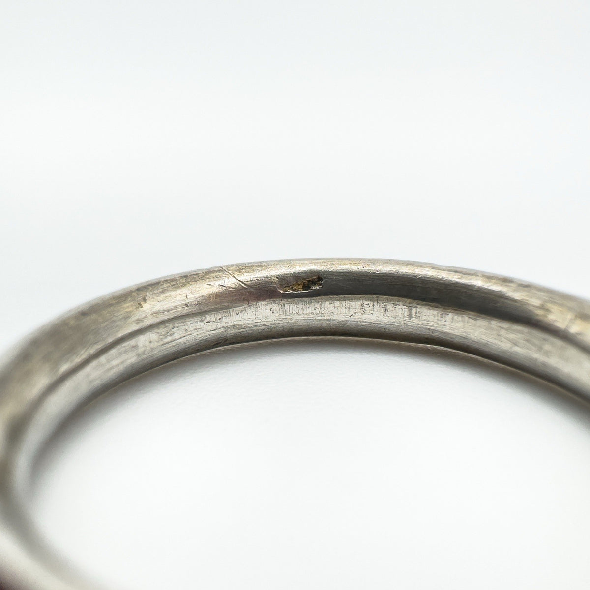 Macro view of inner band showing wear and a faint, possibly incomplete maker's mark