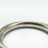 Macro view of inner band showing wear and a faint, possibly incomplete maker's mark