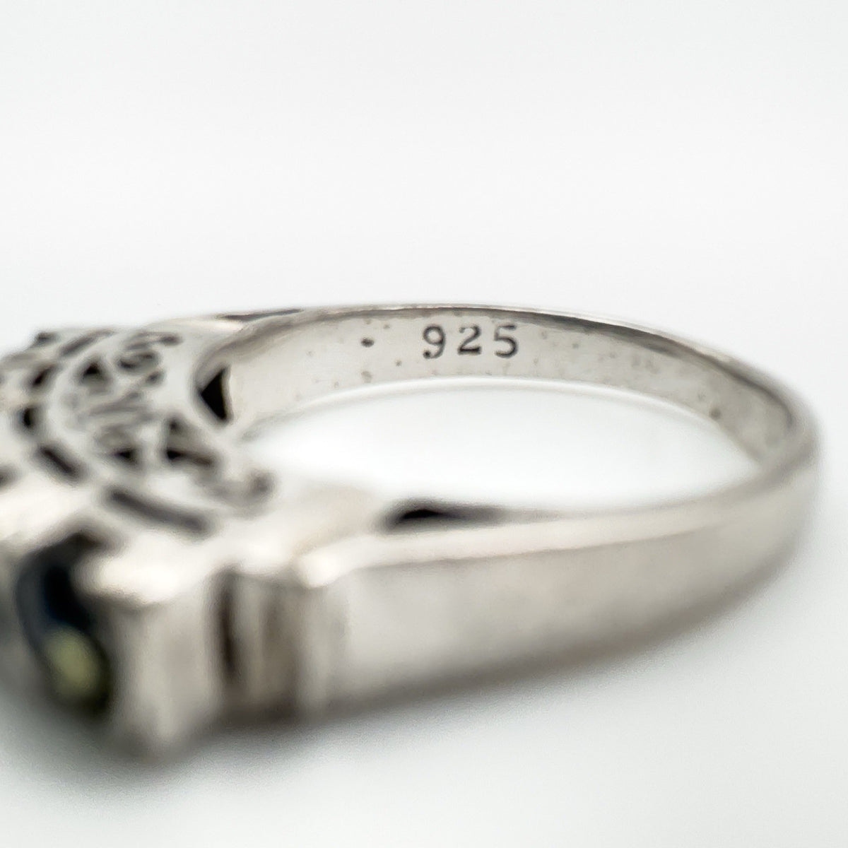 Inner band stamp reading 925 on sterling silver sapphire ring