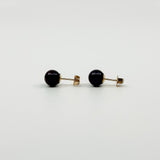 Side profile of vintage 9ct gold cultured black pearl stud earrings with straight posts and backs