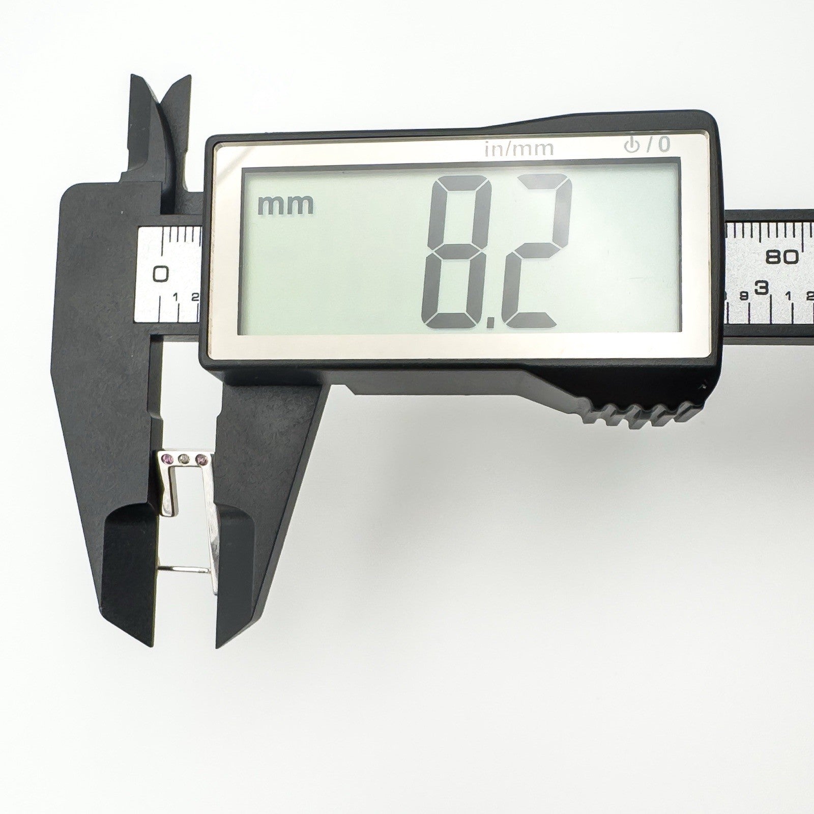 Digital caliper showing width of sterling silver J hoop earring as 8.2mm
