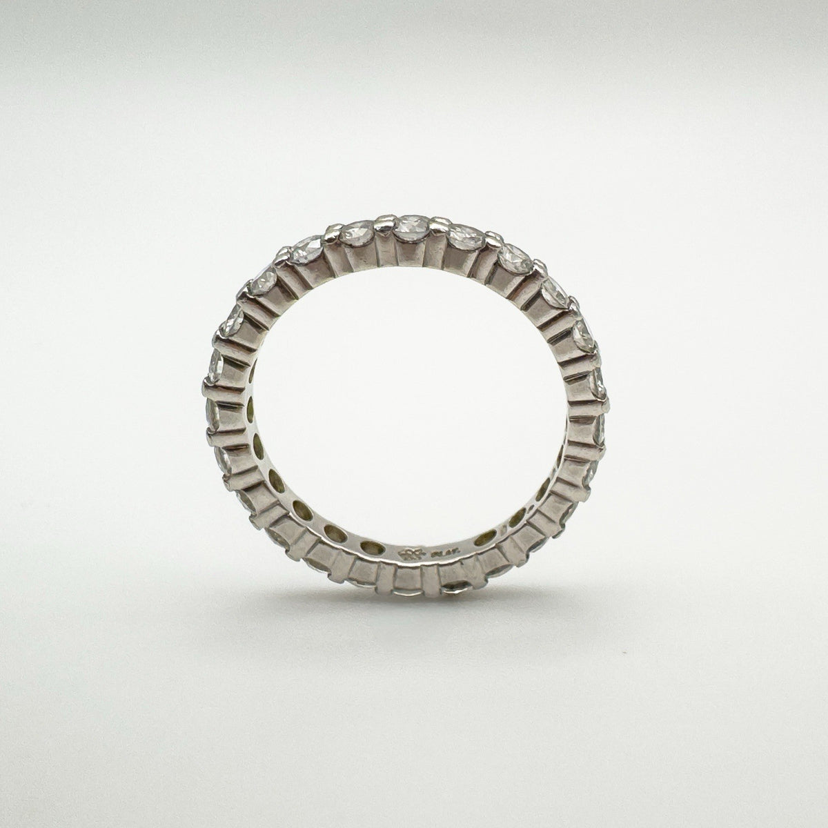 Edge-on view of platinum diamond band showing full eternity setting