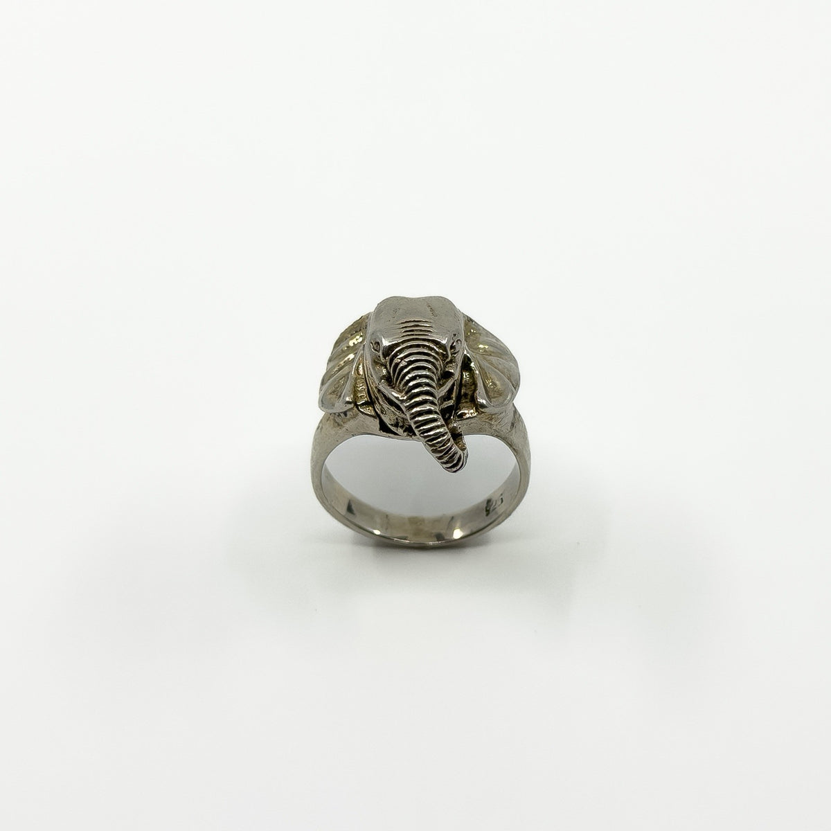 Front view of vintage sterling silver elephant locket ring with trunk, ears and wide band