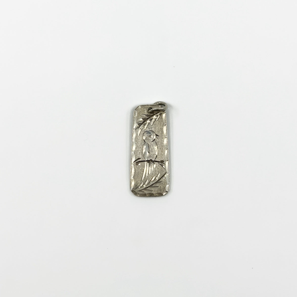 Small vintage sterling silver ingot pendant with bird and leaf engraving to the front.