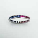 Channel set sapphire and ruby full eternity band in white gold, flat angle