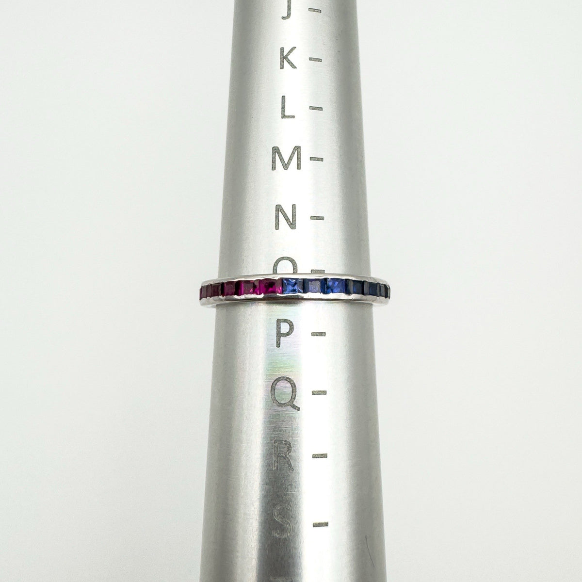 Sapphire and ruby eternity stacking ring shown on UK ring size chart at size O