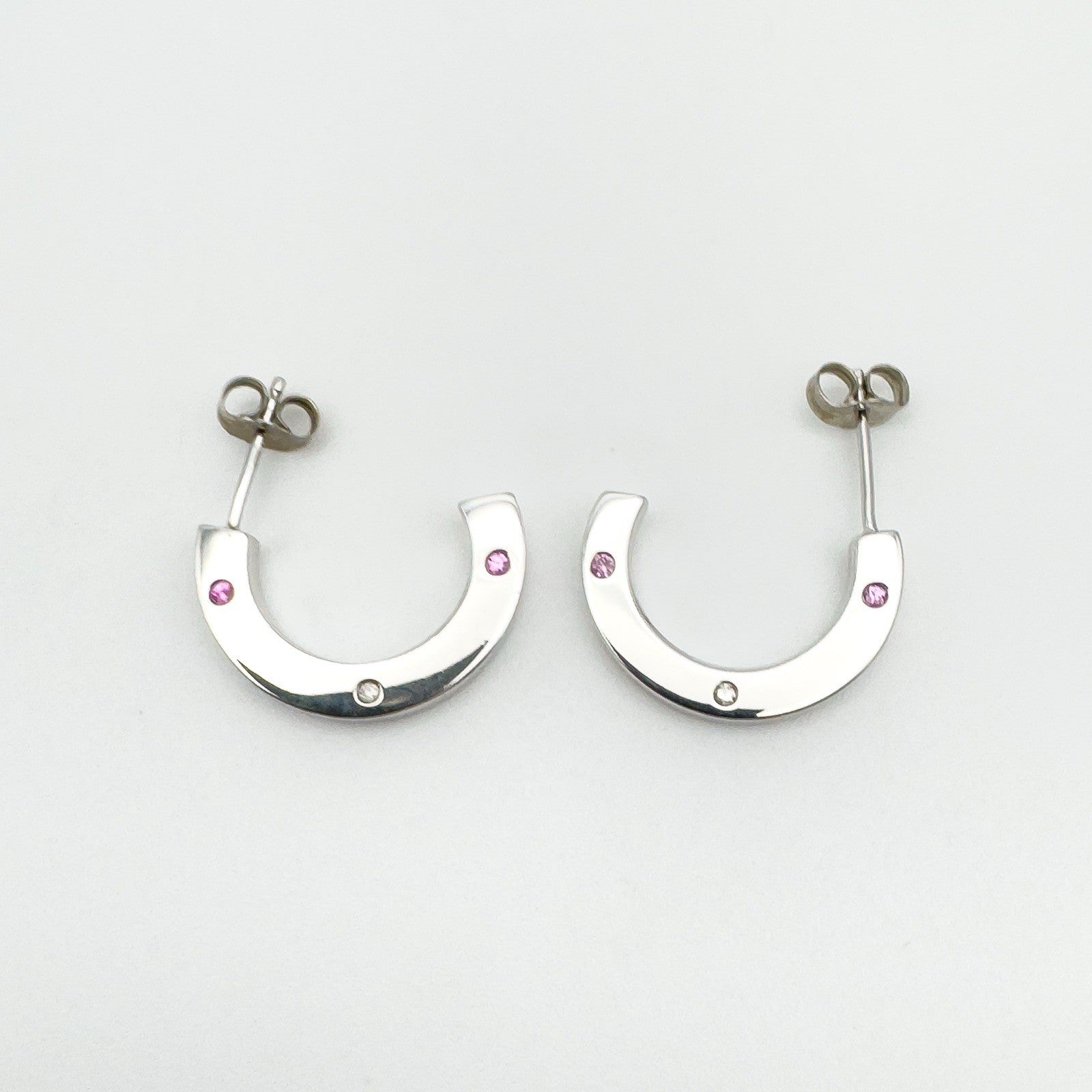 Flat lay showing both sterling silver earrings from above with gemstone placement visible