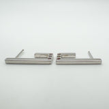 Side profile of sterling silver J half hoop earrings with gemstone settings visible at the base