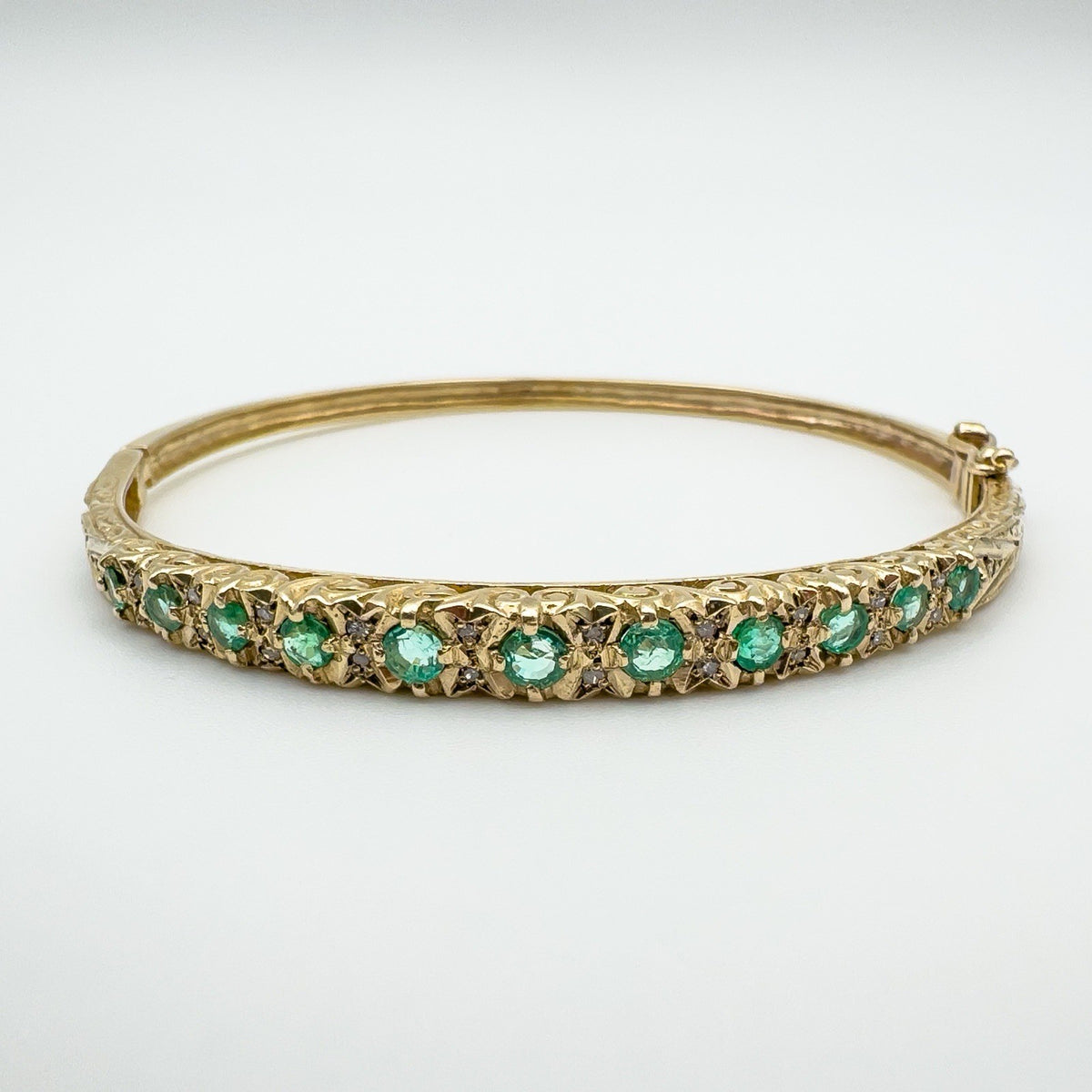 Vintage 9ct gold bangle with emeralds and diamonds front view