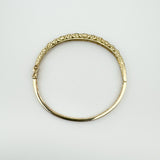 Top view of vintage 9ct gold bangle showing full oval shape and scroll pattern