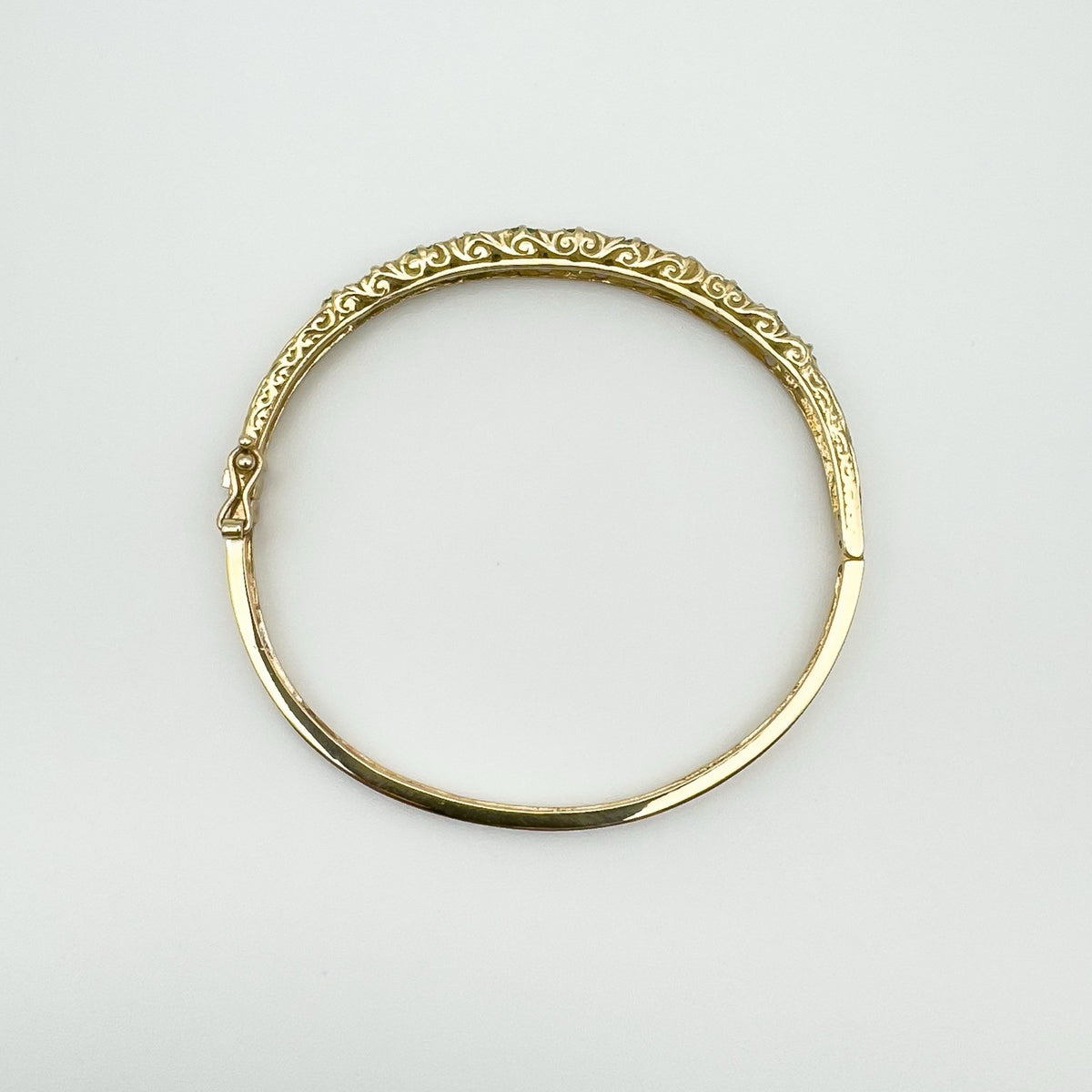 Top view of vintage 9ct gold bangle showing full oval shape and scroll pattern