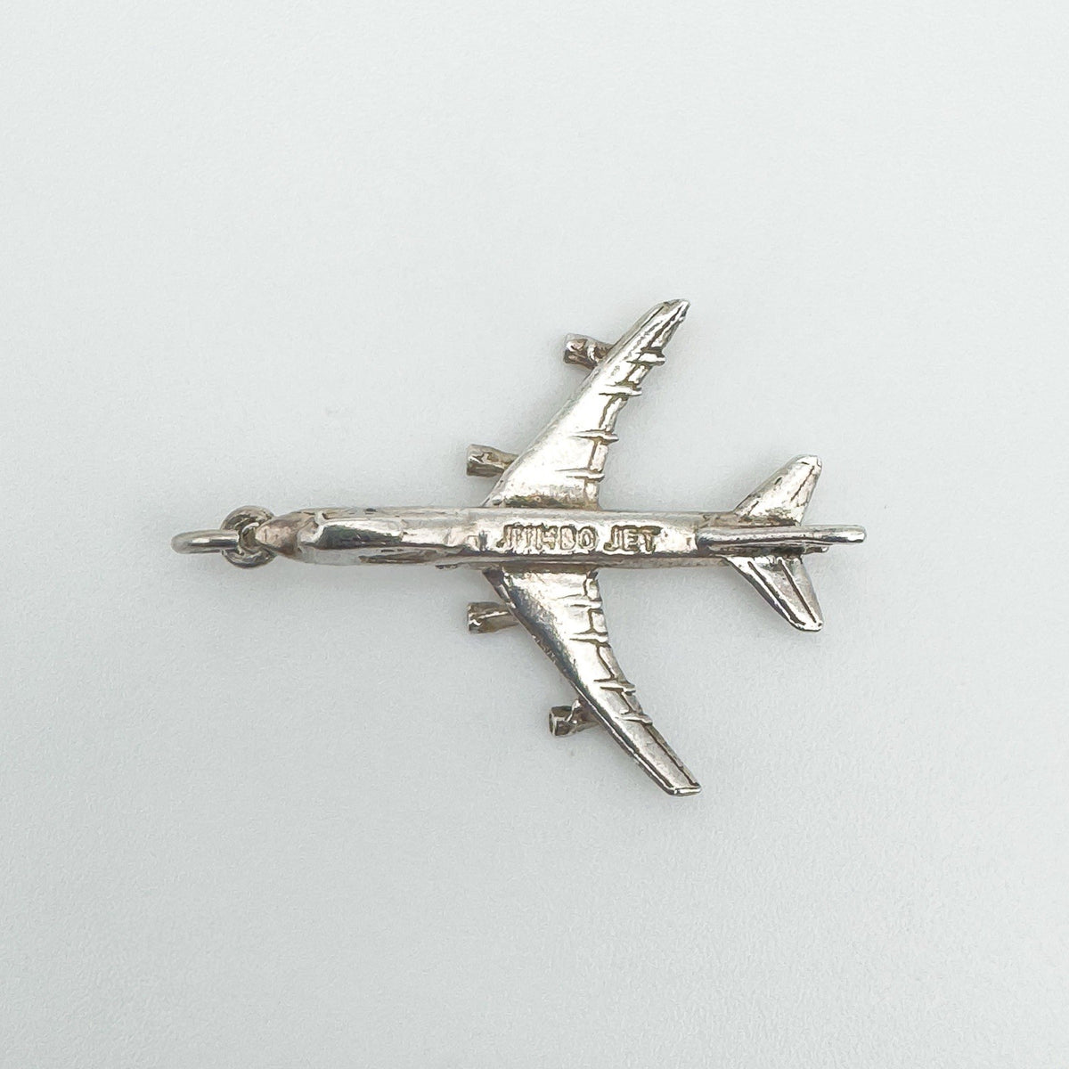 Sterling silver aircraft charm engraved with 'JUMBO JET' on the body