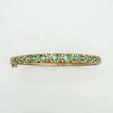 Full view of vintage gold bangle with 11 emeralds and 22 diamonds