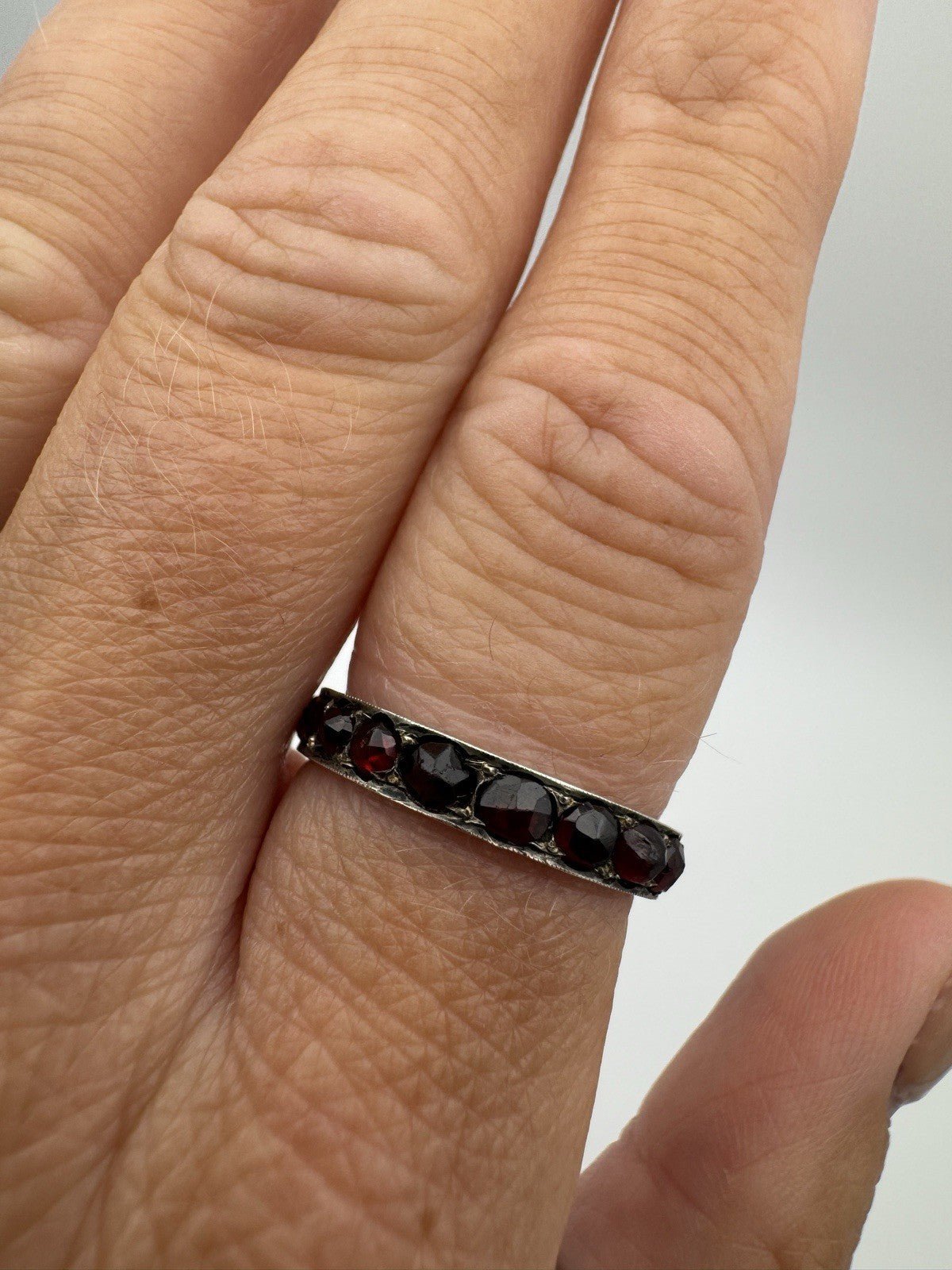 Vintage Bohemian garnet ring worn on finger showing fit and colour contrast