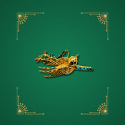 Preloved gold bird brooch with turquoise and coloured gemstones on green Art Deco background