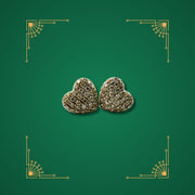 Preloved gold heart-shaped earrings set with diamonds on green Art Deco background
