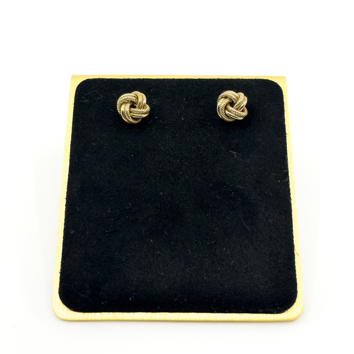 Vintage 9ct gold knot stud earrings displayed on black jewellery stand