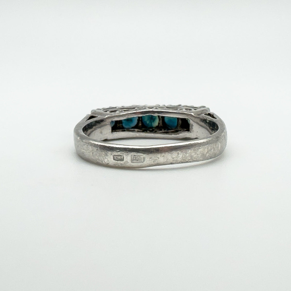 Close-up of ZR and A+VT hallmarks on outer band of vintage sapphire ring