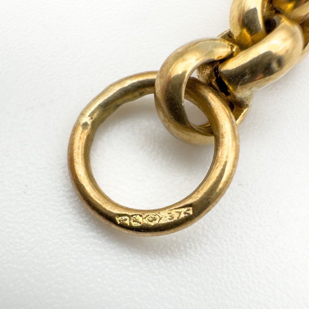 Close-up of 9ct gold jump ring with hallmarks on vintage T-bar charm