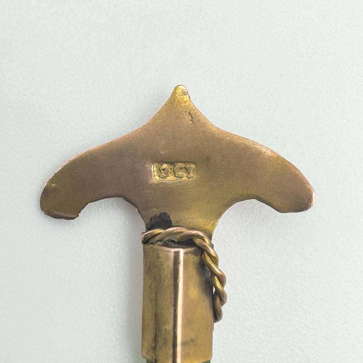 Close-up showing hallmark at the base of the gold anchor design