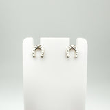 Mini sterling silver horseshoe earrings shown on white display