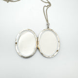 Close-up of inside silver locket showing empty photo compartments