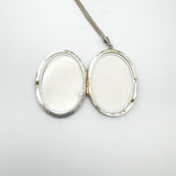 Open locket showing both photo compartments with original frames