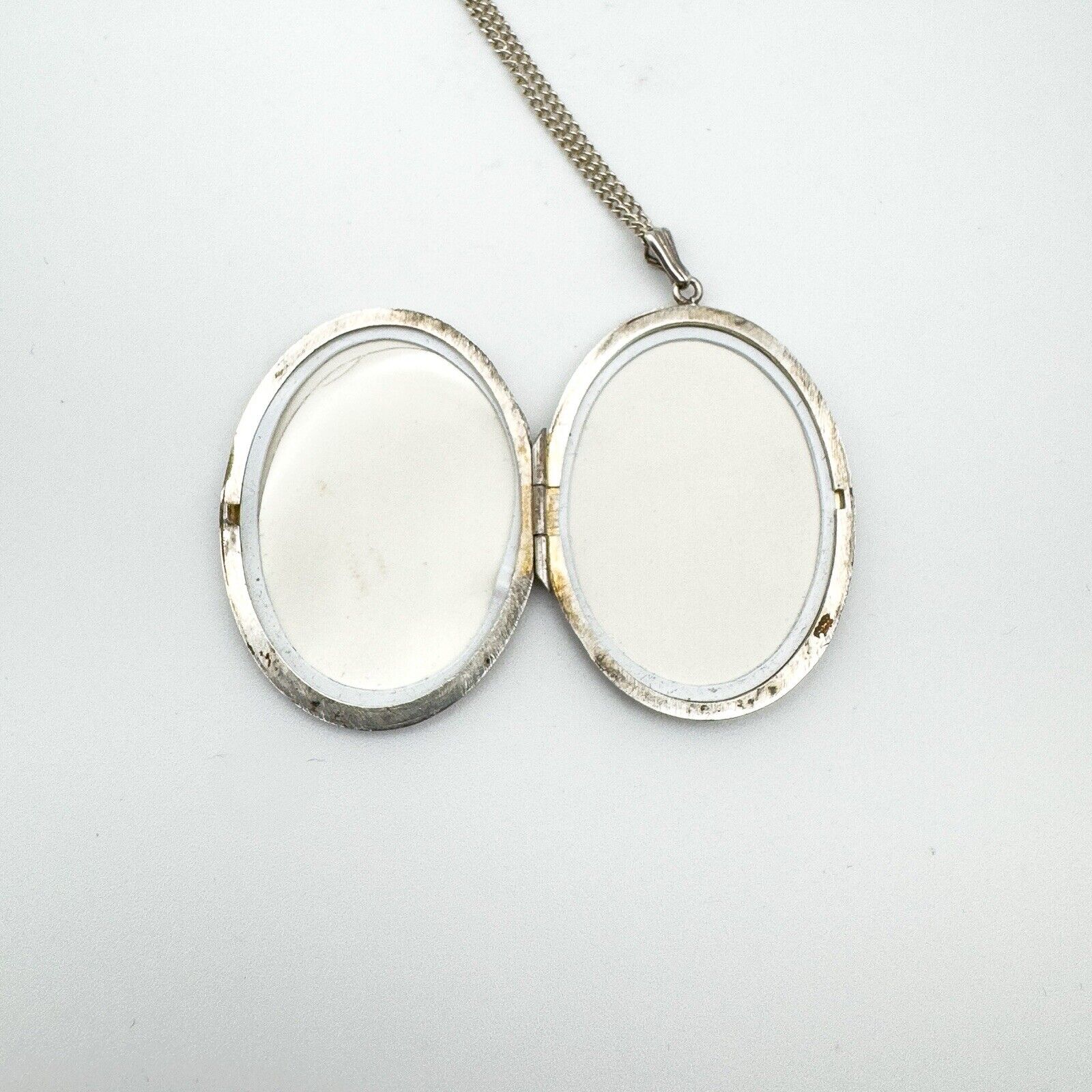 Open locket showing both photo compartments with original frames