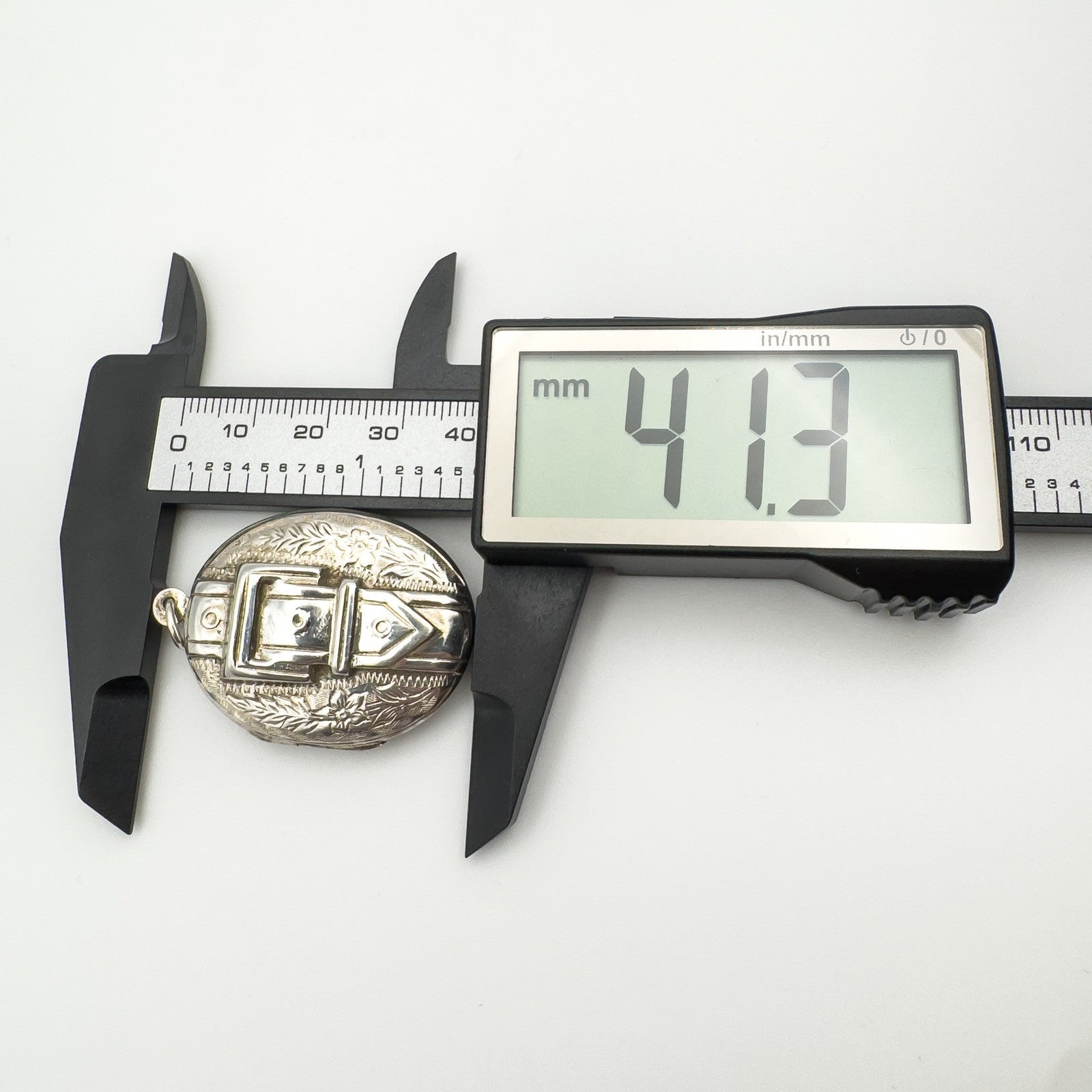 Sterling silver locket height shown as 41.3mm with digital calipers
