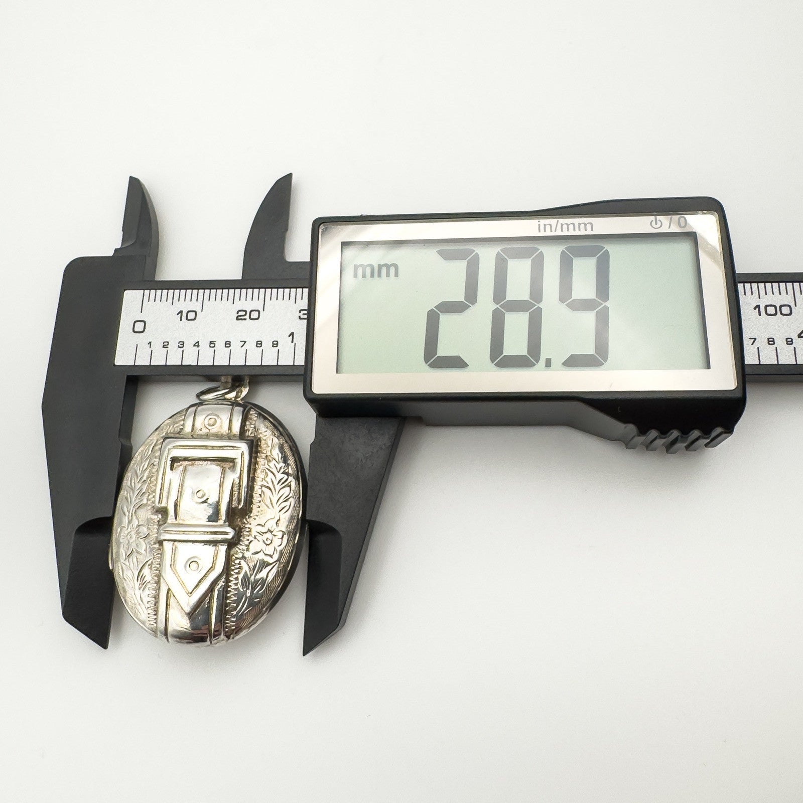 Sterling silver buckle locket width shown as 28.9mm with calipers